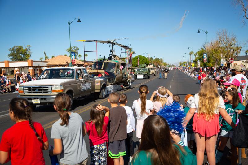 Photo of crowd on Center Street in Mesa watching military vehicles in the parade 